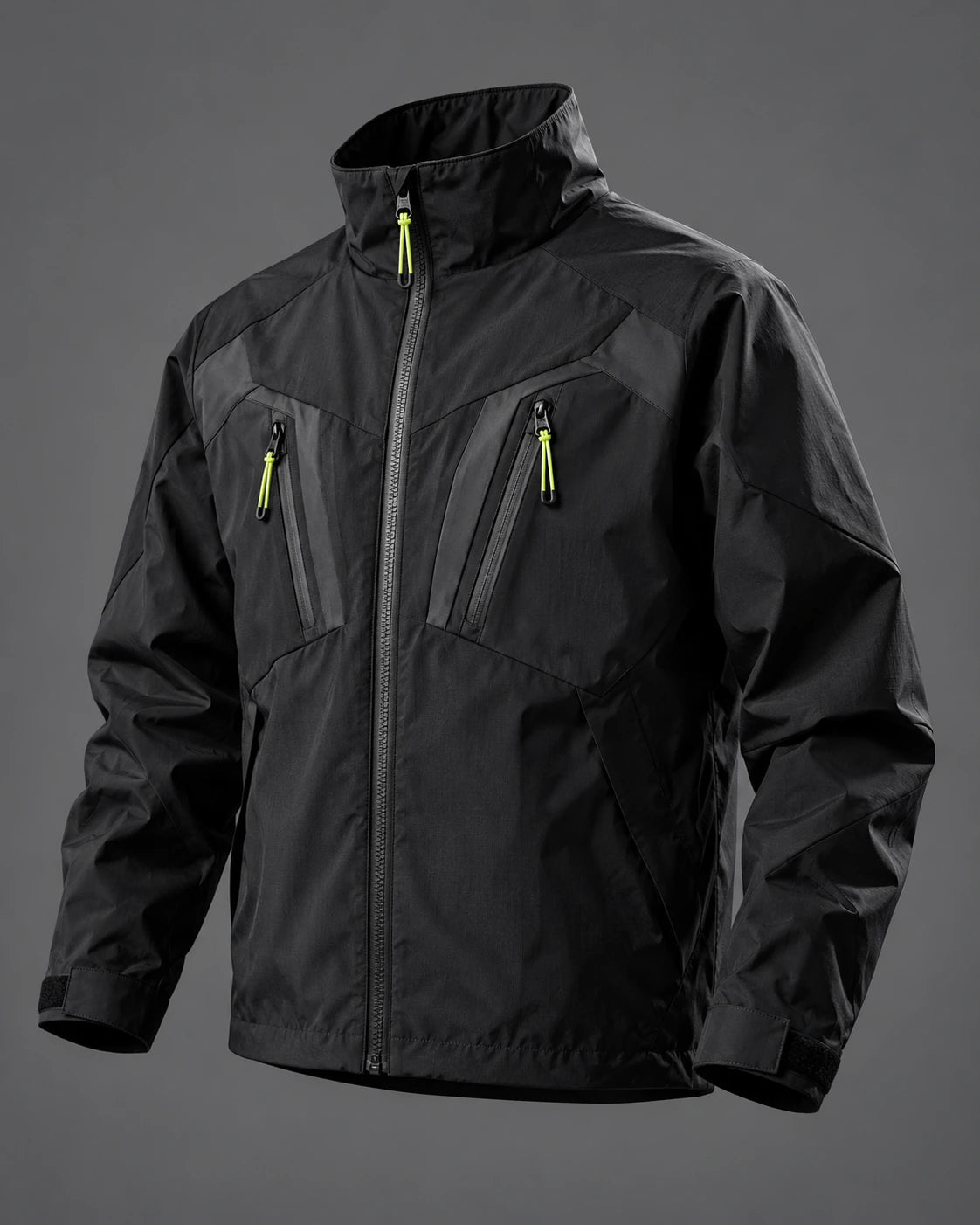 Black utility jacket with a high collar, angular pockets and lime zip pulls on a graphite background.