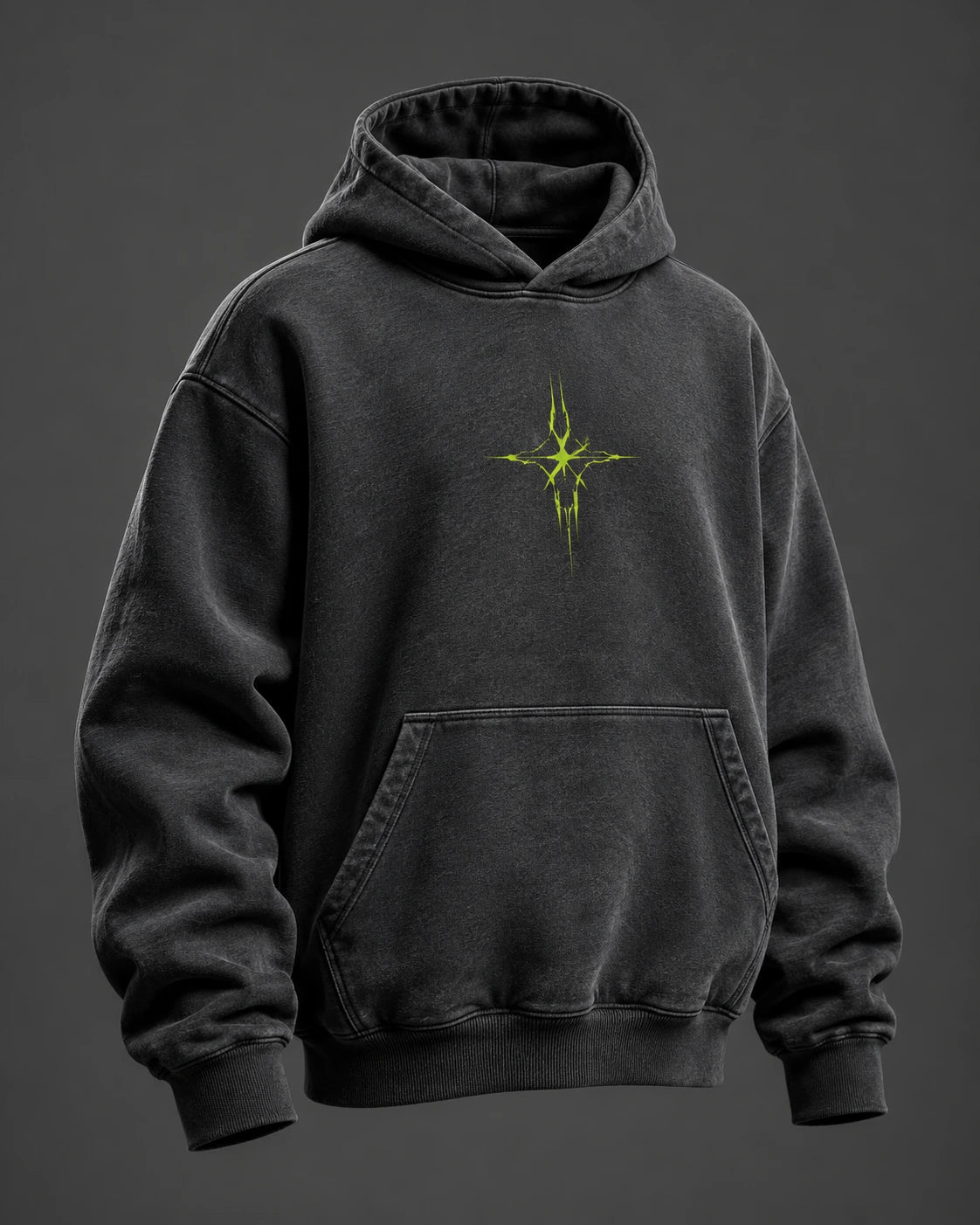 Oversized charcoal hoodie with a kangaroo pocket and abstract lime chest graphic on a grey studio backdrop.
